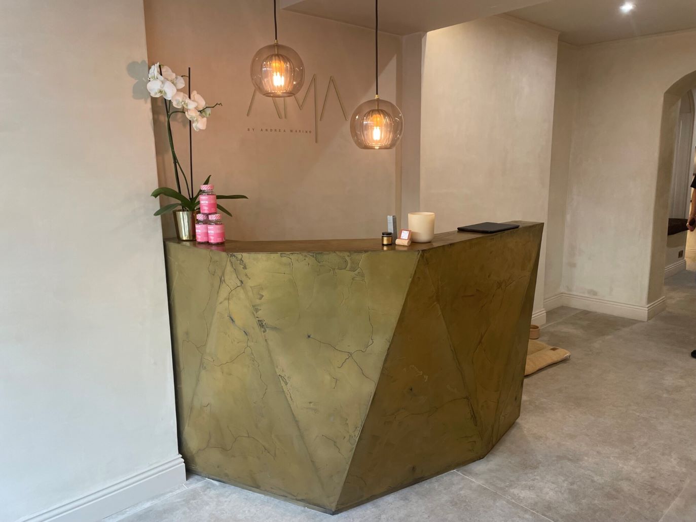 A Reception Desk With A Cracked Liquid Metal Brass Paint Finish