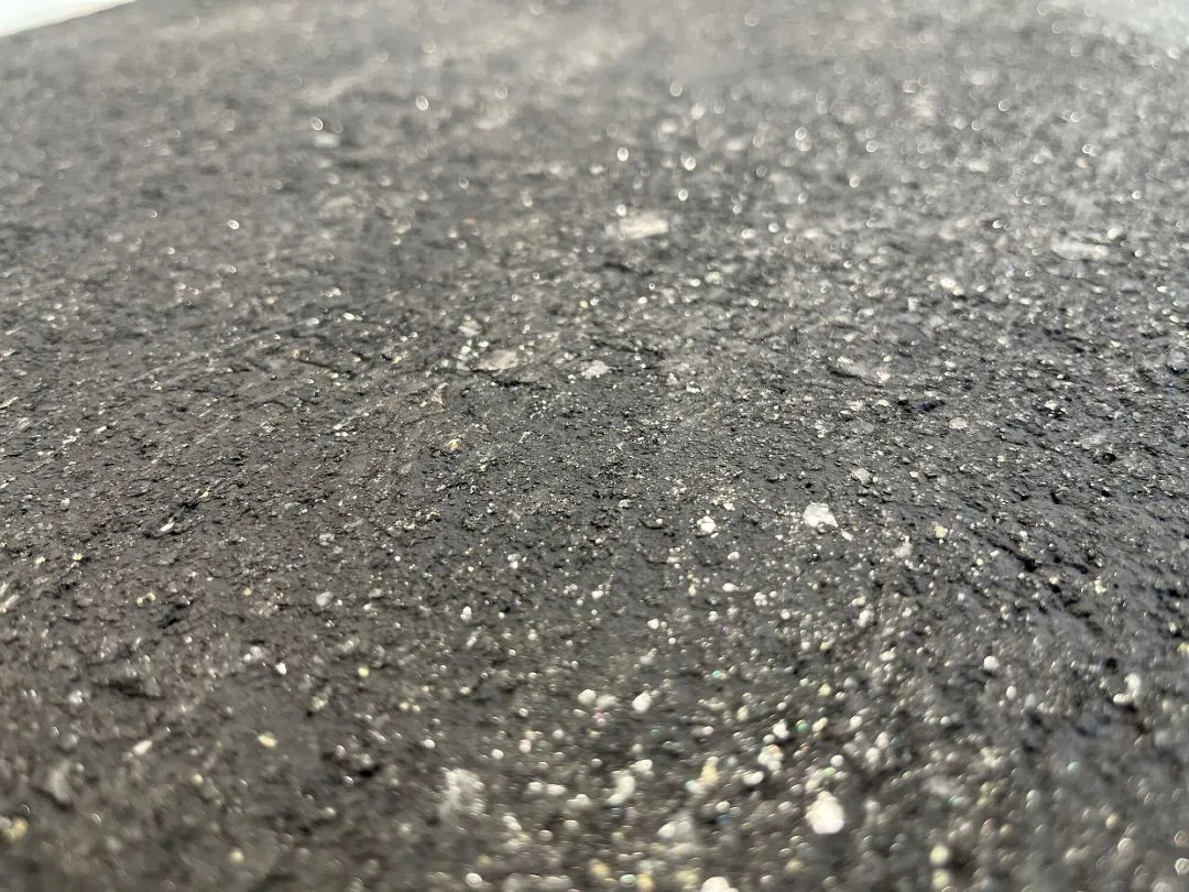 Close up of textured liquid metal surface finish