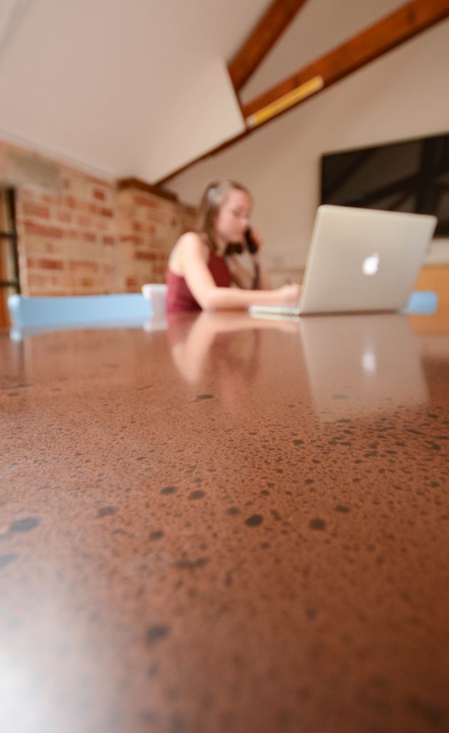 A Person Working From A Copper Coated Table